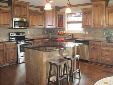 Gorgeous open kitchen with black granite, stainles