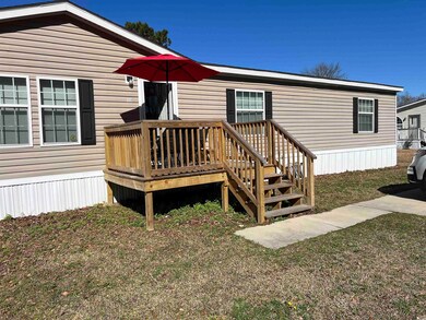 Exterior space featuring a deck and a lawn