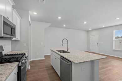 Kitchen with stainless steel appliances, a sink, d