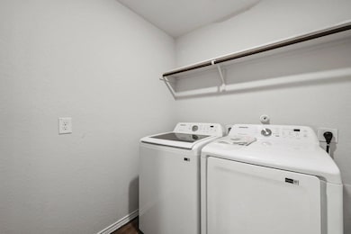 Laundry area featuring baseboards, separate washe