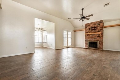 Unfurnished living room with a ceiling fan, healthy amount of natural light, dark wood-style flooring, and lofted ceiling