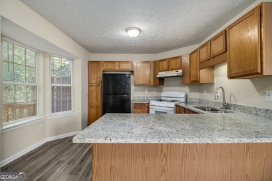 The Kitchen offers Oak Cabinets, Granite Countertops, and an Adjacent Dining Room with French Doors that open to a Private Deck