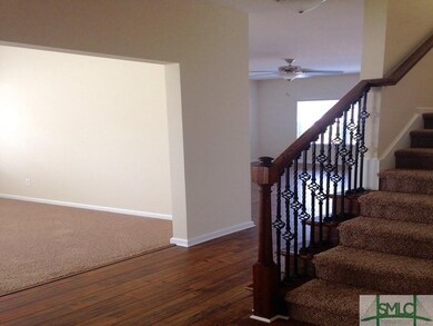 ENTRANCE FOYER WITH IRON BALLISTERS HANDRAILS