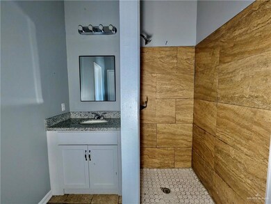 Full bath with a shower stall and vanity