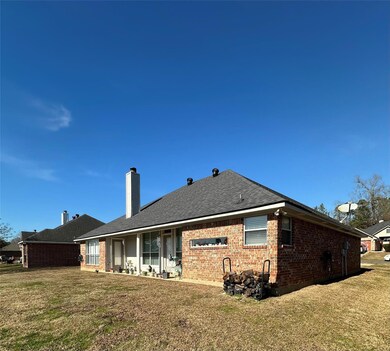REAR OF HOME FEATURING COVERED PATIO