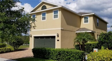 Front of home with mature landscaping.