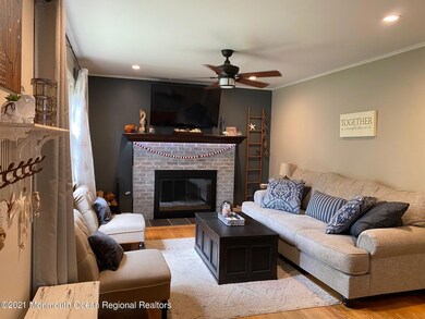 LIVING ROOM WITH WOODBURNING FIREPLACE