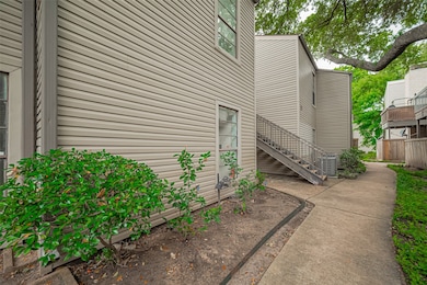 A quiet walkway winds through and around the building, setting a peaceful tone before you even step inside.