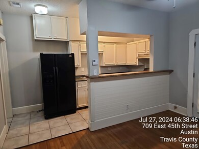 Kitchen featuring black refrigerator with ice dis