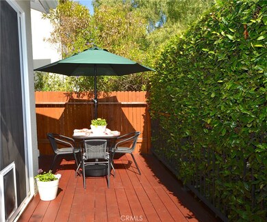 FRESHLY REFINISHED THE REDWOOD DECK IS PROTECTED FROM VIEW WITH A LOVELY HEDGE WALL. A VERY PRIVATE OUTSIDE OASIS.