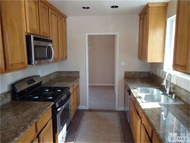 large kitchen with wood cabinets and  granite coun