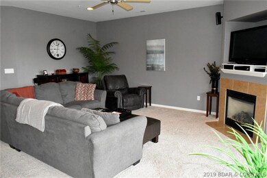 Gas fireplace in living area with TV and surround