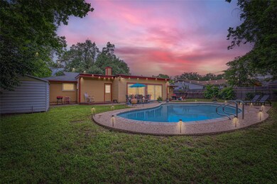 Pool at dusk with a patio area