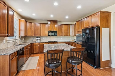 This chef's kitchen includes a gas cooktop and plenty of storage for all your culinary needs. Recessed lighting brightens the space, showcasing the beautiful wood floors.