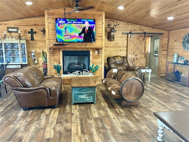 Living room featuring wood finished floors, a barn