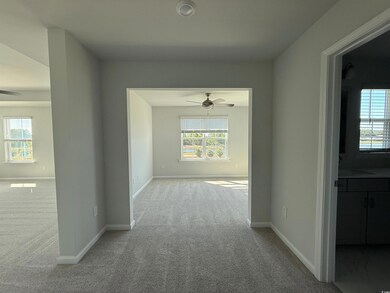 Corridor featuring baseboards and carpet