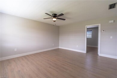 Spare room featuring ceiling fan and hardwood / wo