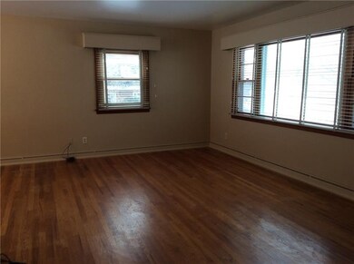 Spacious living room with plently of natural light through large front windows