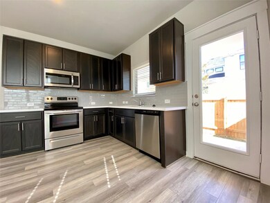 Kitchen with stainless steel appliances, light co