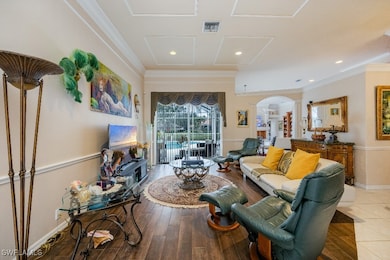 Living room with ornamental molding and hardwood /