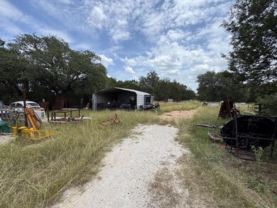 View of yard featuring a carport and driveway