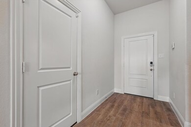 Entryway with wood finished floors and baseboards