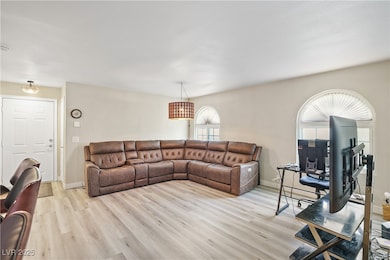 Living area featuring light wood finished floors and baseboards