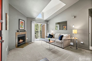 Light and bright living space with a skylight and cozy wood burning fireplace