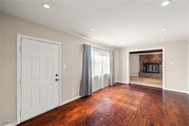 Unfurnished living room featuring a fireplace, bas