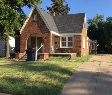 Tudor house with a front yard and a porch-2 separa