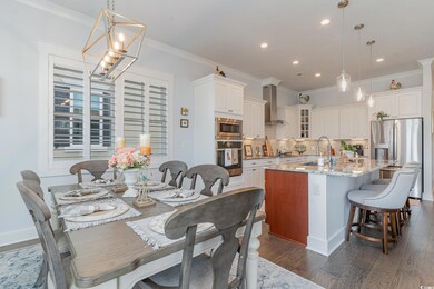 Dining space featuring sink, dark wood-type floori