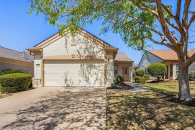 View of front facade featuring driveway, a garage