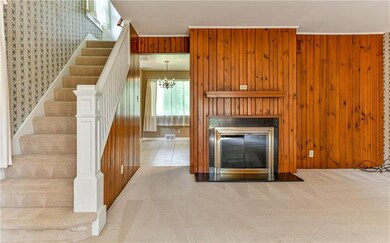 Doorway into the kitchen (left of fireplace)