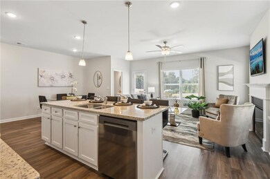 Kitchen featuring a sink, white cabinetry, dishwas
