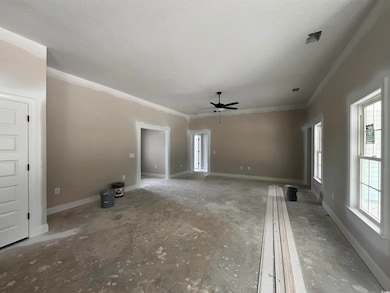 Unfurnished living room with ceiling fan, crown molding, baseboards, and a textured ceiling