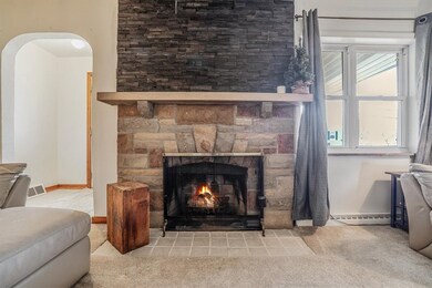 Elegant lounge area with a stone-accented fireplac