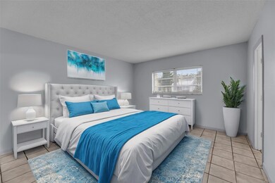 Large bedroom with tile flooring and double closet