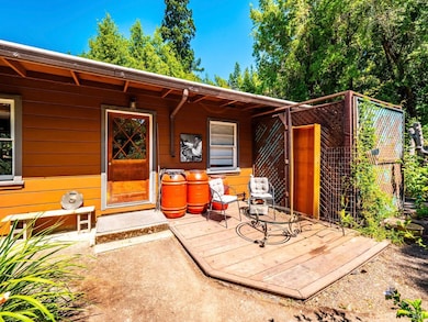The main home welcoming entry with a sunny sitting area. Step inside and you’re greeted by a well-loved home—full of warmth, practicality, and the inviting character of another era.