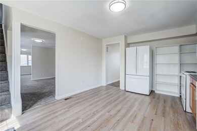 Kitchen With Dining, Living, and Laundry Rooms Off