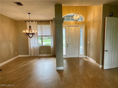 Entryway with a chandelier and light tile patterned floors