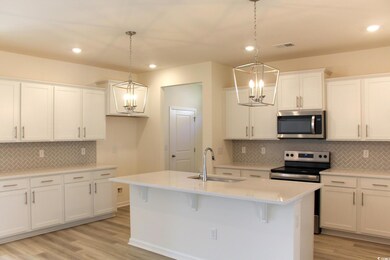 Kitchen featuring backsplash, stainless steel appliances, white cabinetry, recessed lighting, and light wood-style floors