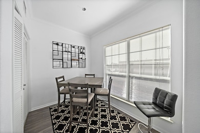 This photo shows a bright dining area and large windows with blinds providing ample natural light. The space feels open and inviting.