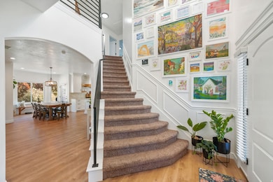 Stairs with arched walkways, wood finished floors, a decorative wall, and recessed lighting