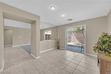 Dining area with neutral paint and tile flooring.