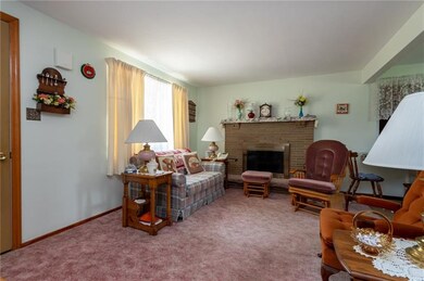 Wood burning fireplace in living room with picture