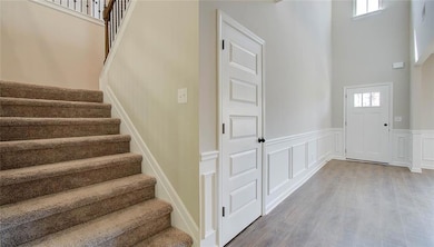 Stairs with plenty of natural light, wood-type flo