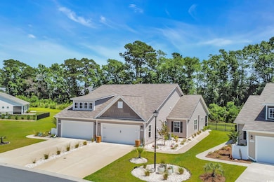 View of front of house with concrete driveway and a shingled roof