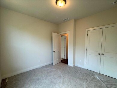 Unfurnished bedroom with carpet and a closet