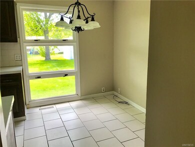 Dine-in kitchen overlooks large fenced yard.