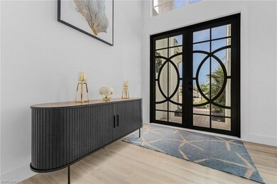 Foyer with hardwood / wood-style flooring and beau